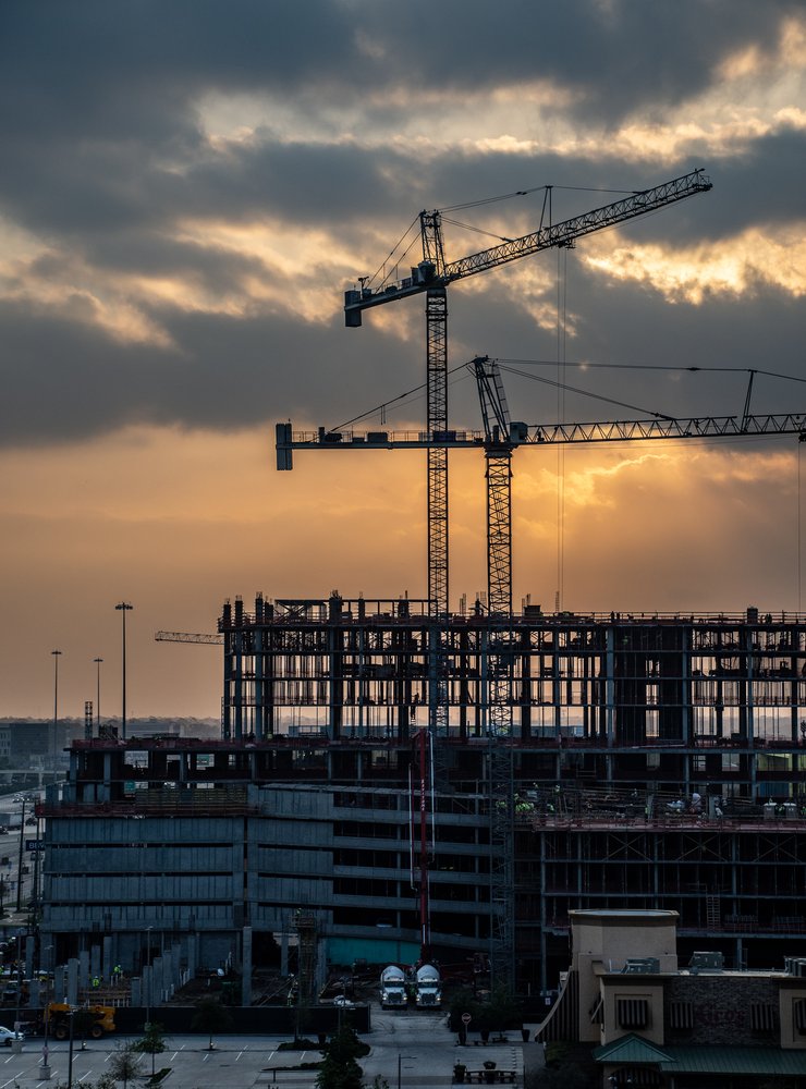 Construction site of a multi level building with cranes to represent the industries that KORE serves
