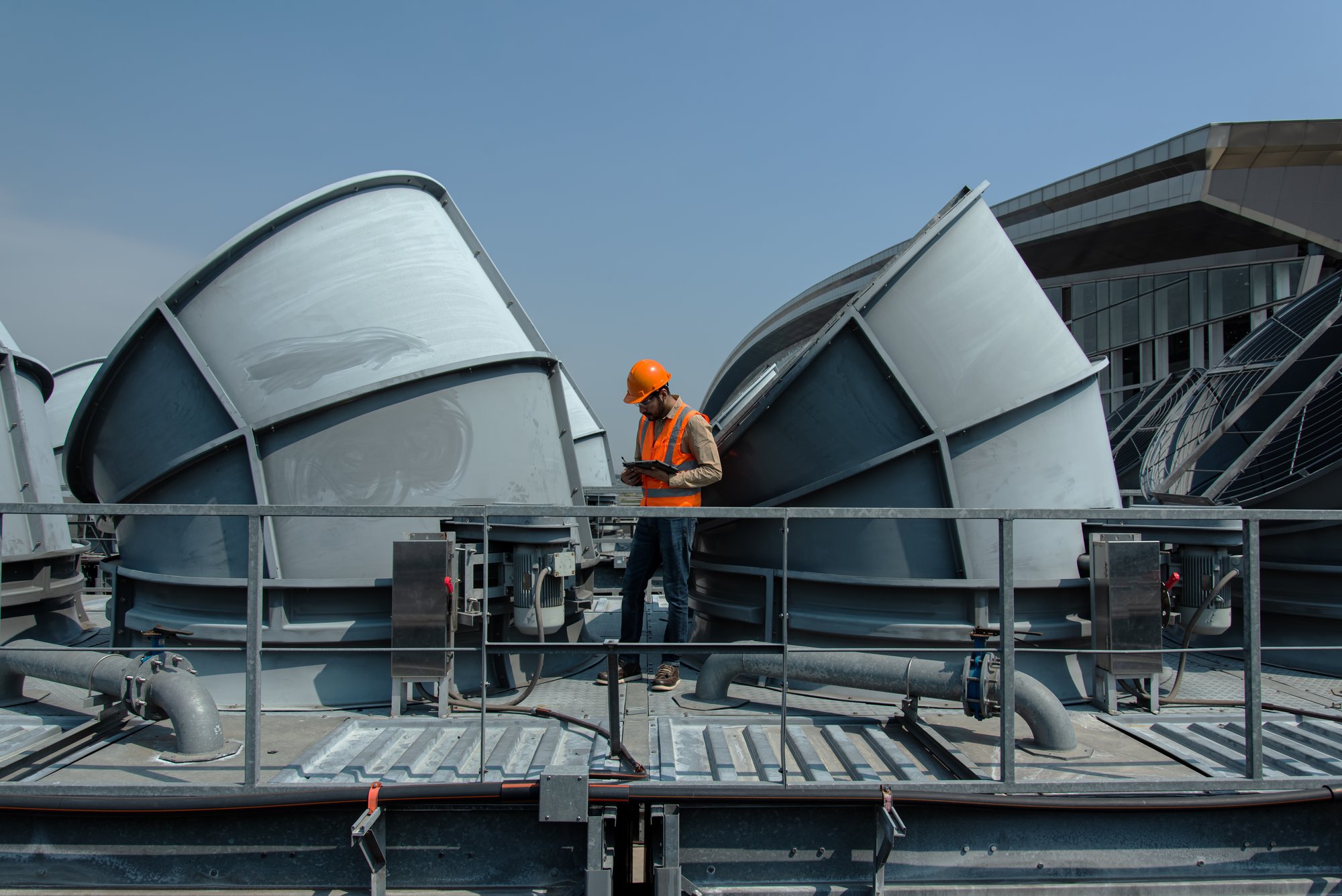 Engineer checking the industry cooling tower air conditioner is water cooling tower air chiller HVAC of large industrial building to control air system to represent hvac manufacturer rep industry